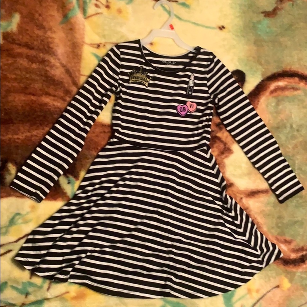 A girls shirt with an attached skirt.